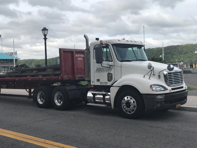 White truck with small flatbed for deliveries