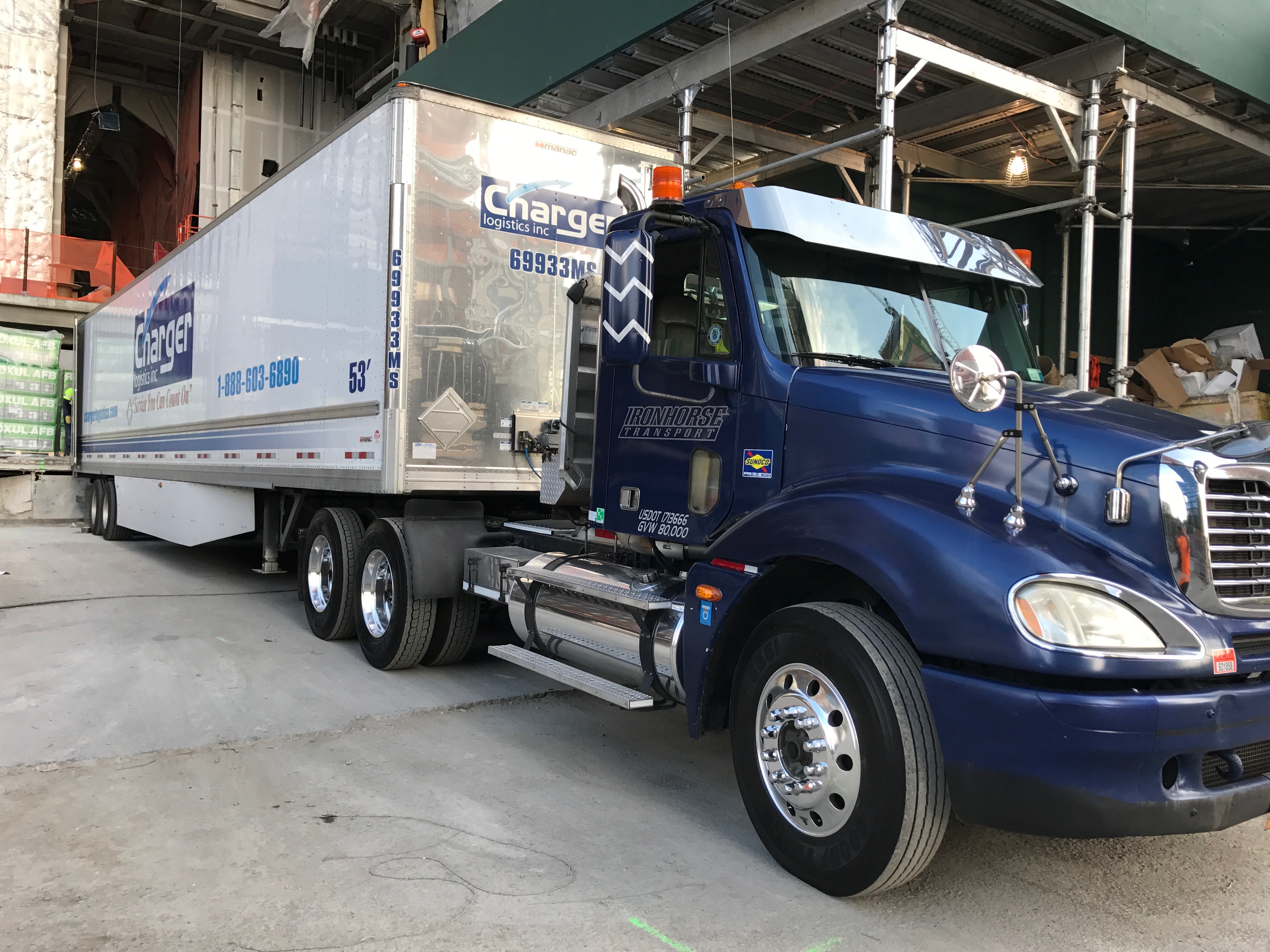 Blue Iron Horse Transport truck on city street