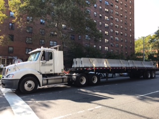 Iron Horse Transport flatbed truck shipping large materials in New York City