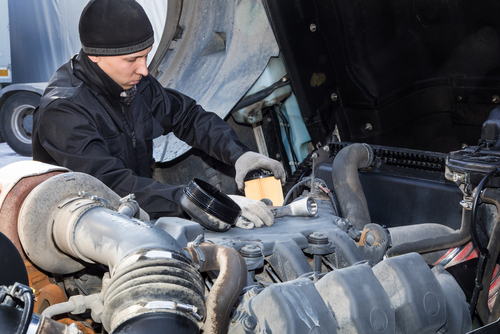 man performing maintenance on truck