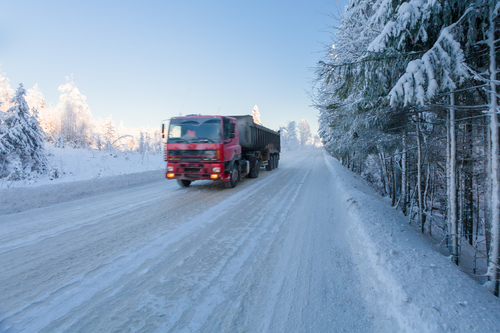 red truck driving during winter