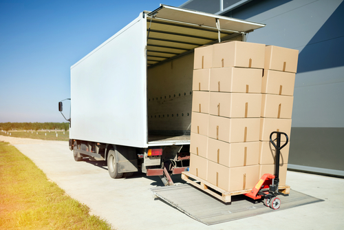 box truck bringing up boxes on a lift gate