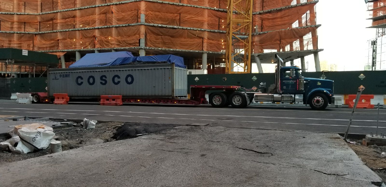 Iron Horse's flatbed truck with an out of gauge trailer being delivered to a job site