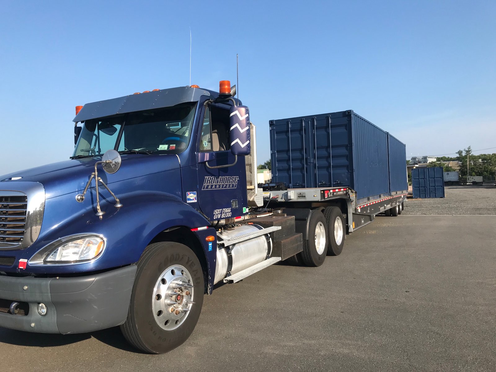 Iron Horse Transport flatbed truck with a container waiting to be moved