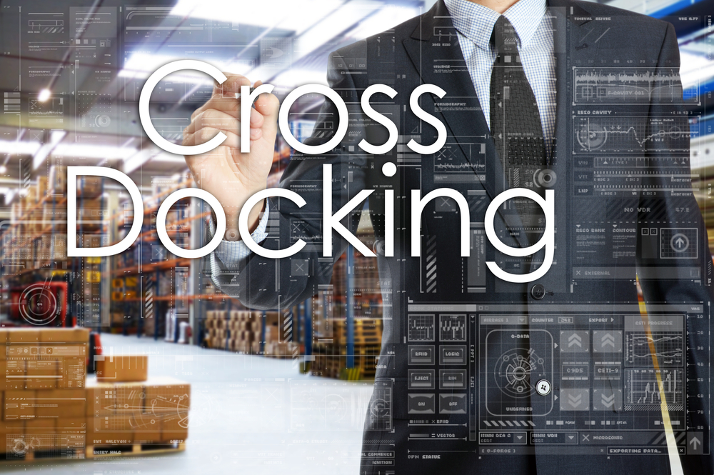 the businessman is writing things connected with the logistics in warehouse. Cross Docking