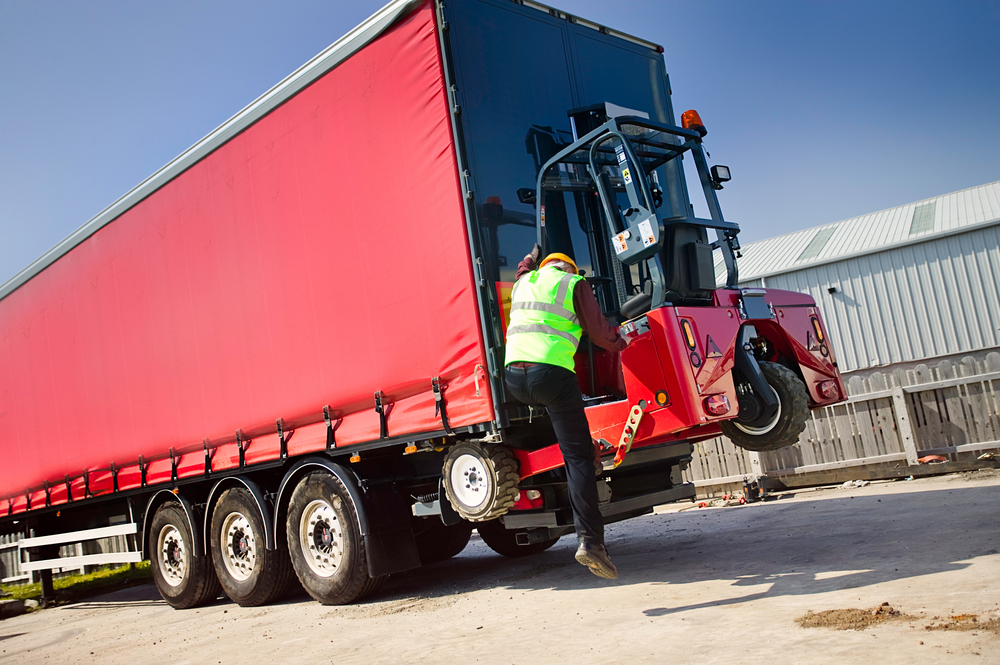 Mounted forklift being removed to unload truck